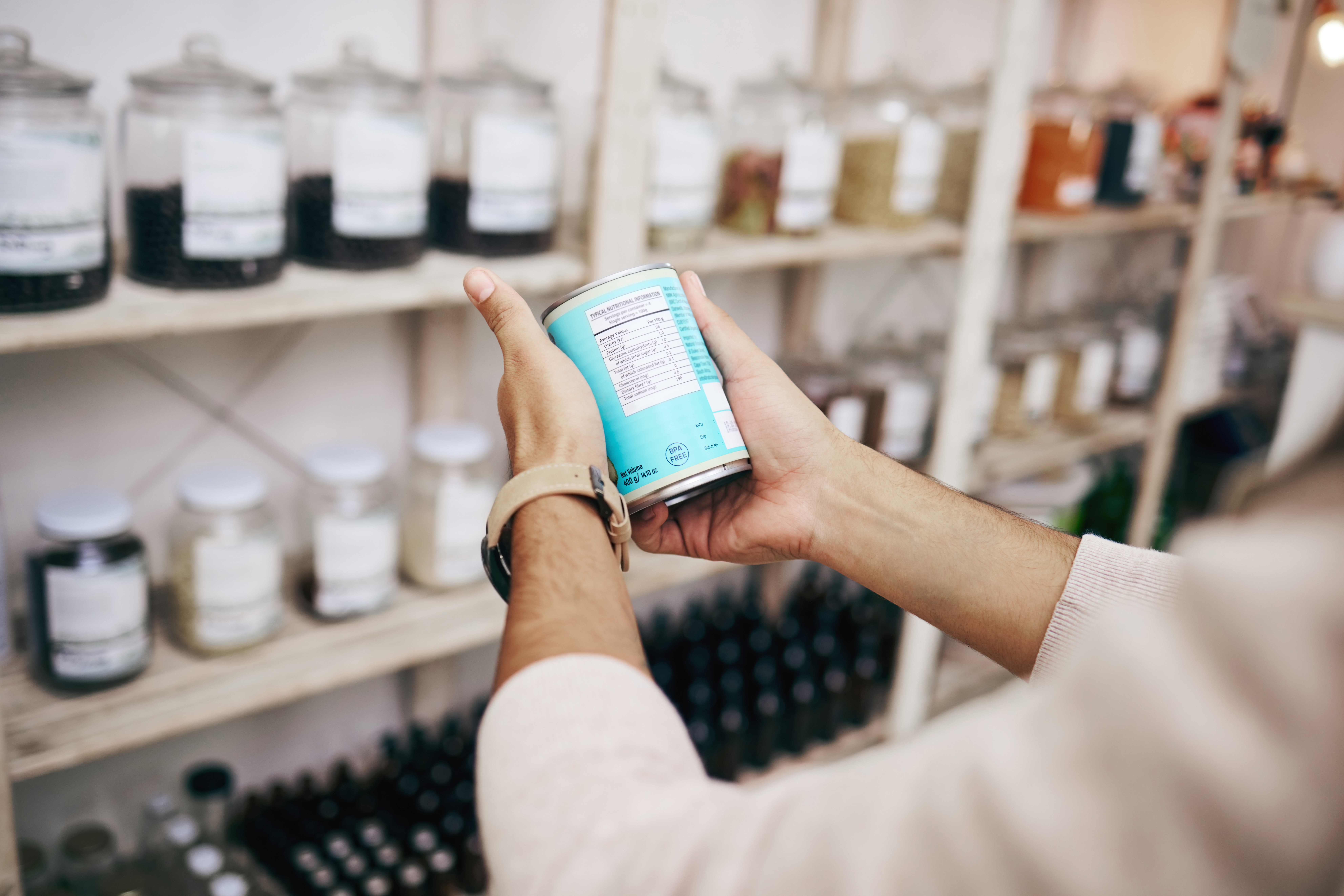 Hands reading a label carefully